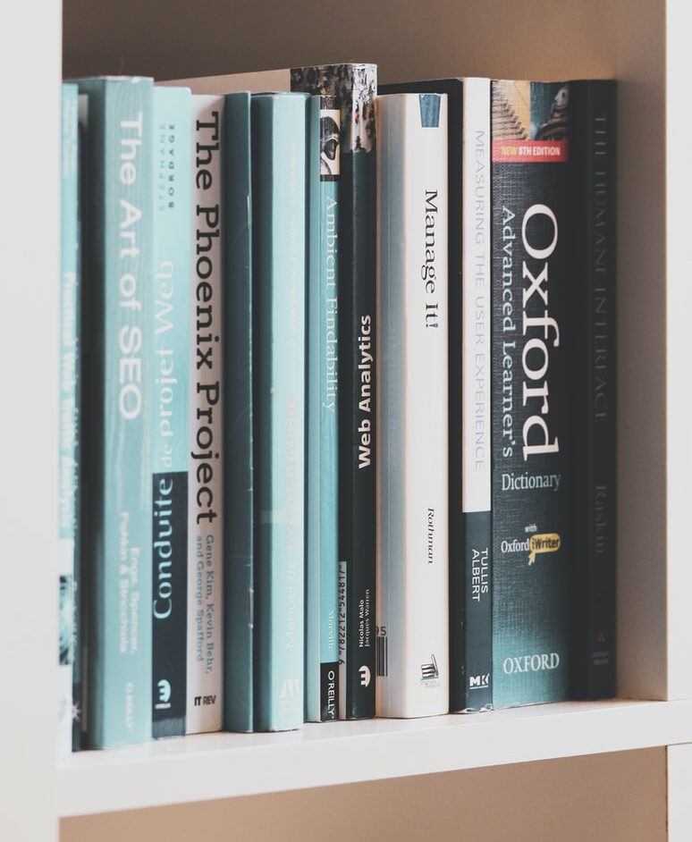 books on brown wooden shelf